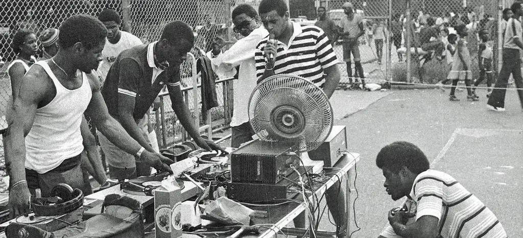 Who is recognized as the first hip-hop DJ in the Bronx to set up turntables in the city park?